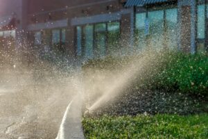 Automatic sprinkler system spraying in the sunlight
